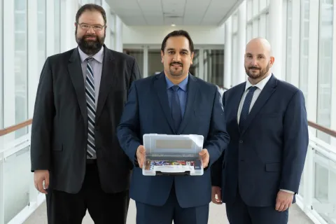 Left to right: David Bigelow, Hamed Okhravi, and Jason Martin display the Timely Address Space Randomization (TASR) software package they co-developed at Lincoln Laboratory.