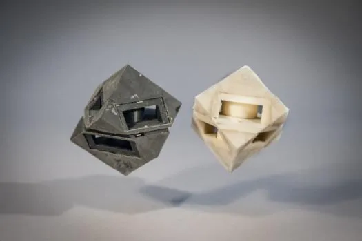 Bouncing, cube robot with shock-absorbing “skins” that transfer less than half of the energy that would normally be transferred to the ground.