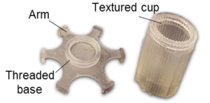 Disassembled rheometer base and sample container (textured cup)