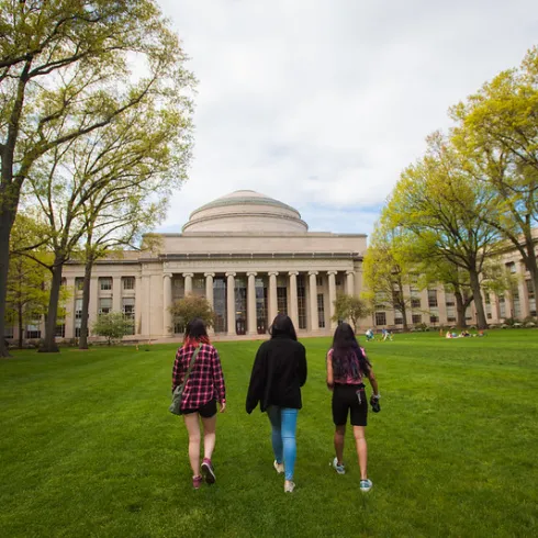 Three students walking toward the MIT dome